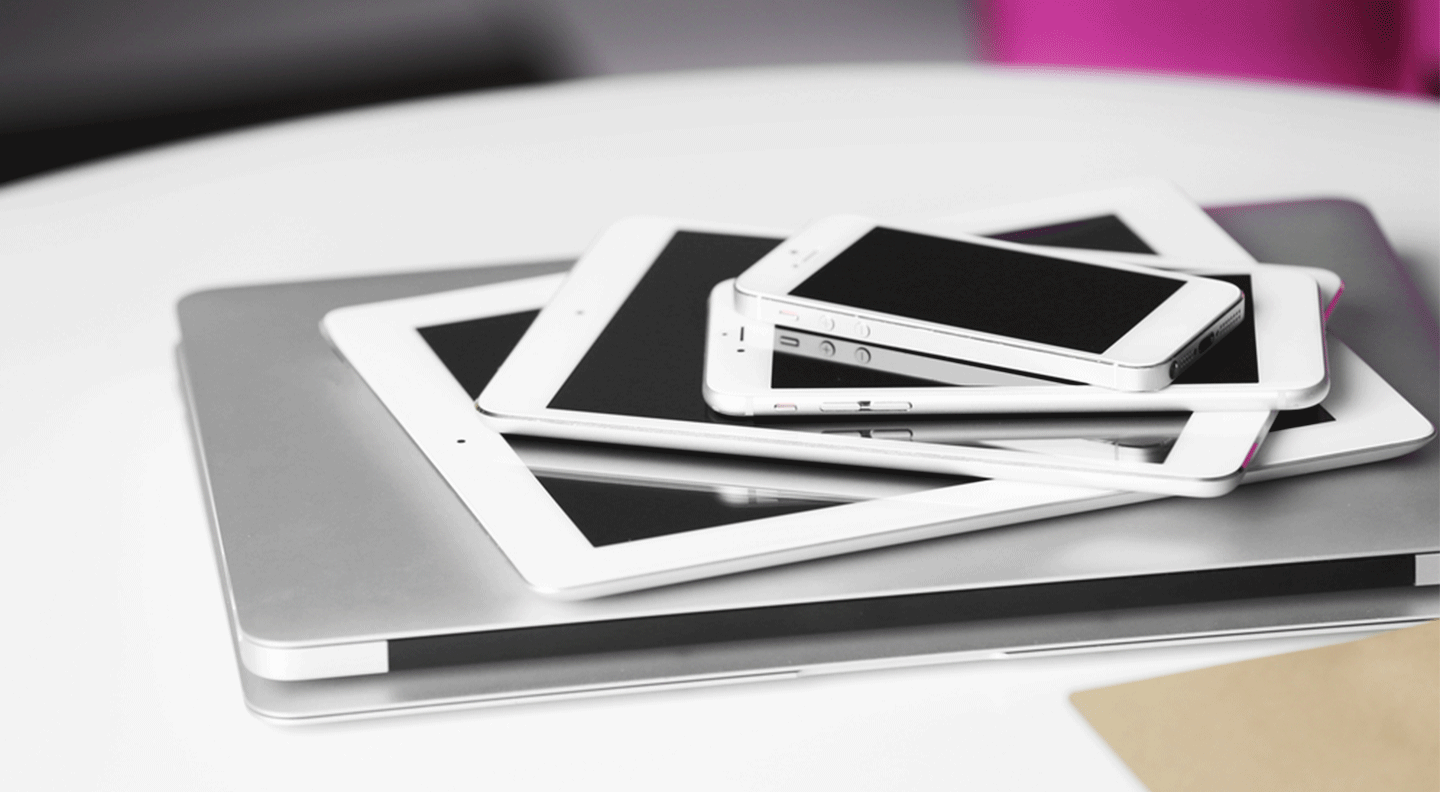 pile-of-various-electronics-on-white-table