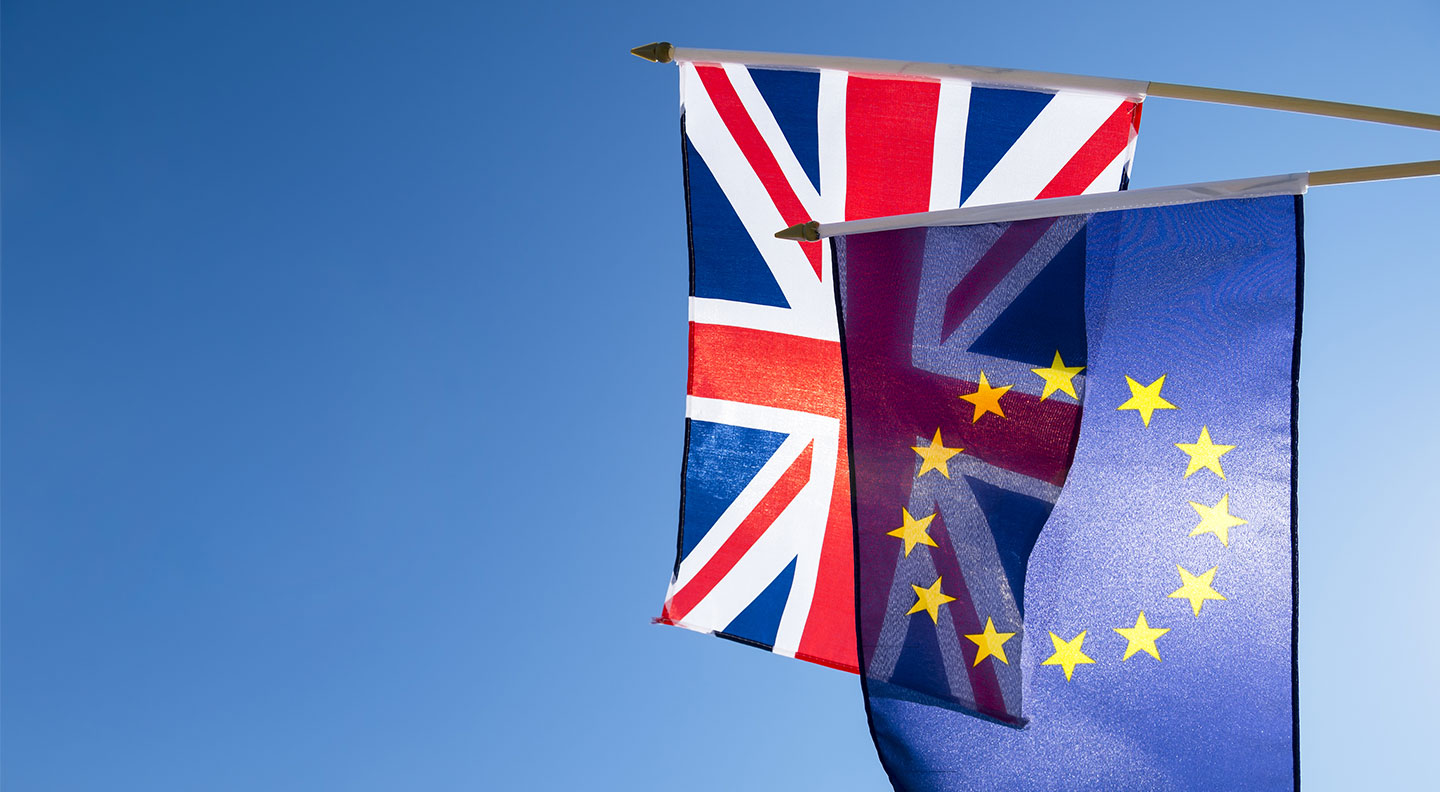 European-Union-and-British-Union-Jack-flag-flying-in-front-of-bright-blue-sky-in-preparation-for-the-Brexit-EU-referendum