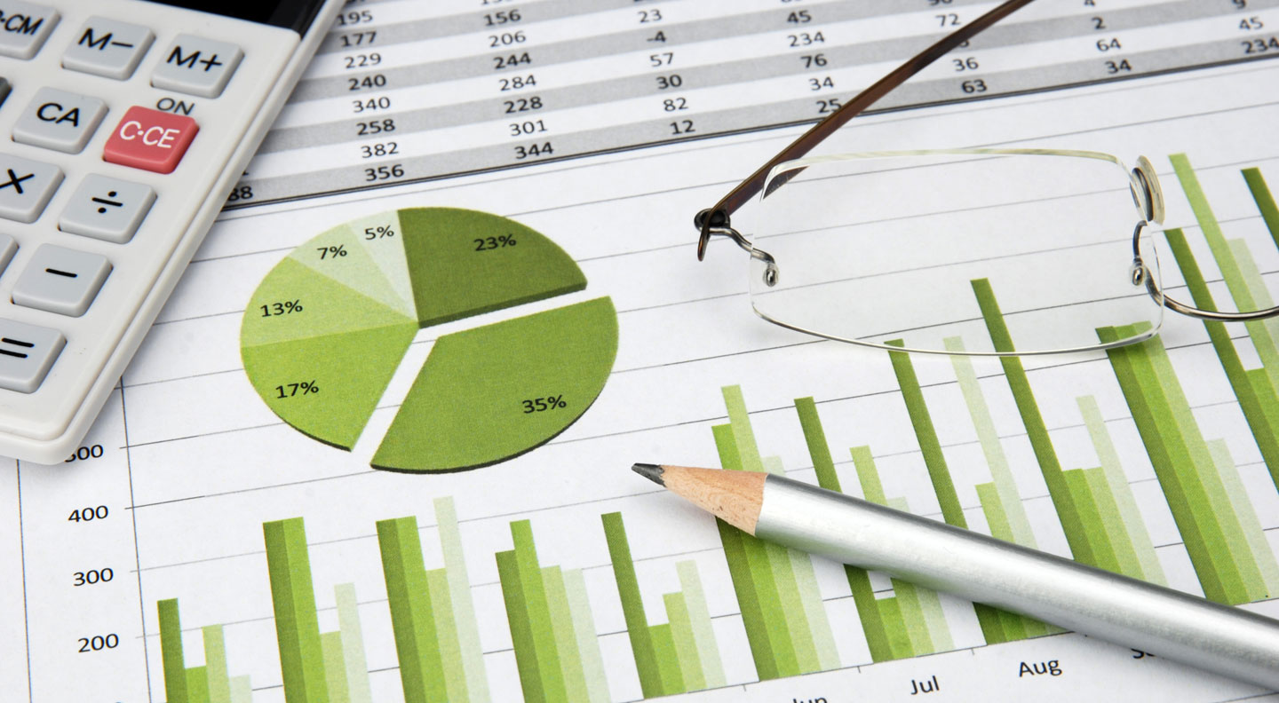 Green charts with calculator pen glasses
