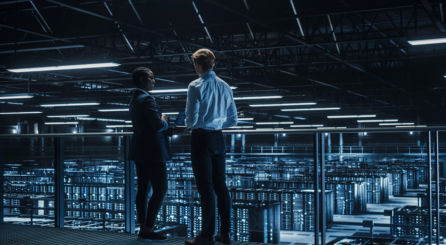 Two IT Professionals on Bridge Overlooking Cloud Computing Server Farm