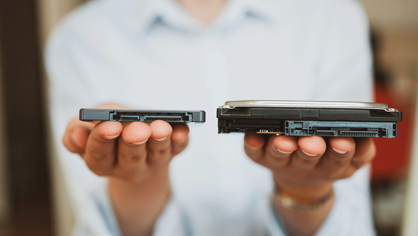 woman holding ssd and hdd