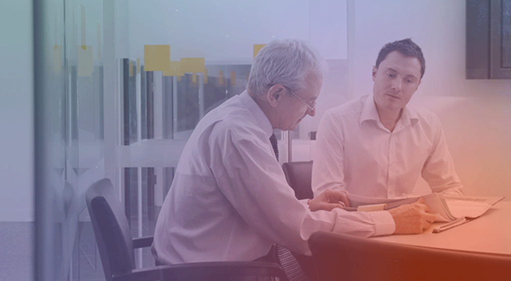 two men looking at documents in office