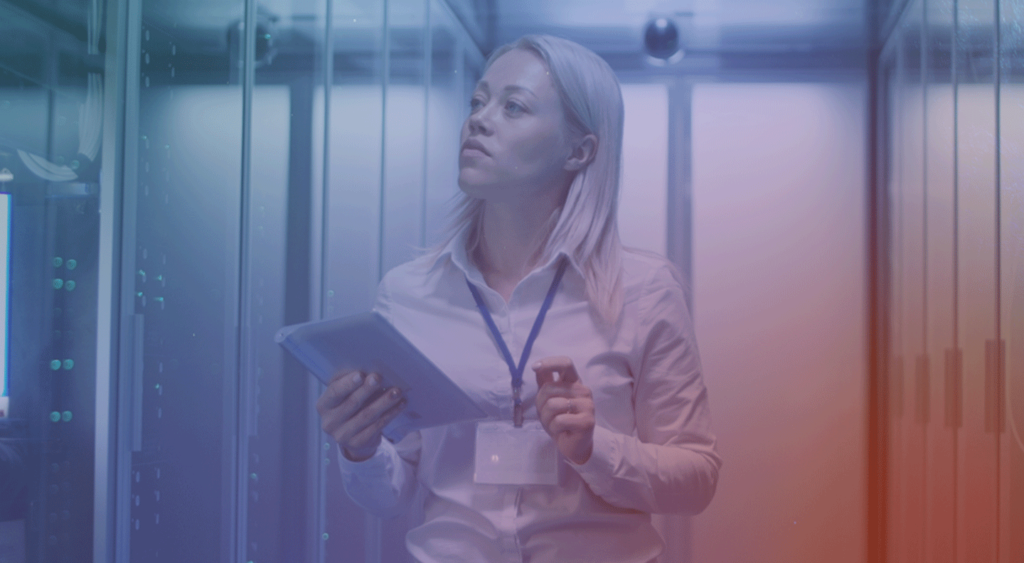 female in data center holding clip board