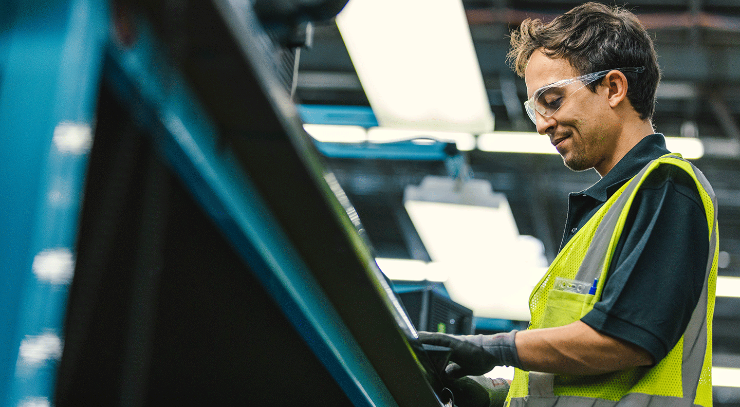 male employee at circular center wearing gloves and protective eye glasses