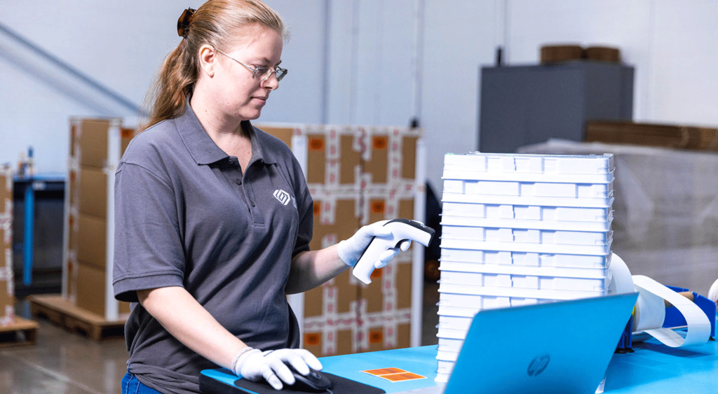 Sims Lifecycle Services employee scanning RAM trays for tracking