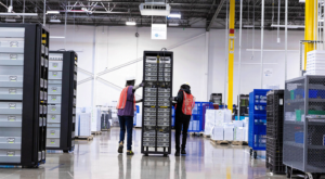 two male staff moving server racks in circular center