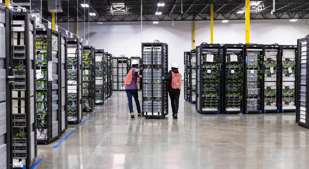 two sims lifecycle services employees moving server racks