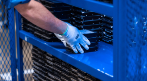 view of employee stacking hard drives in container