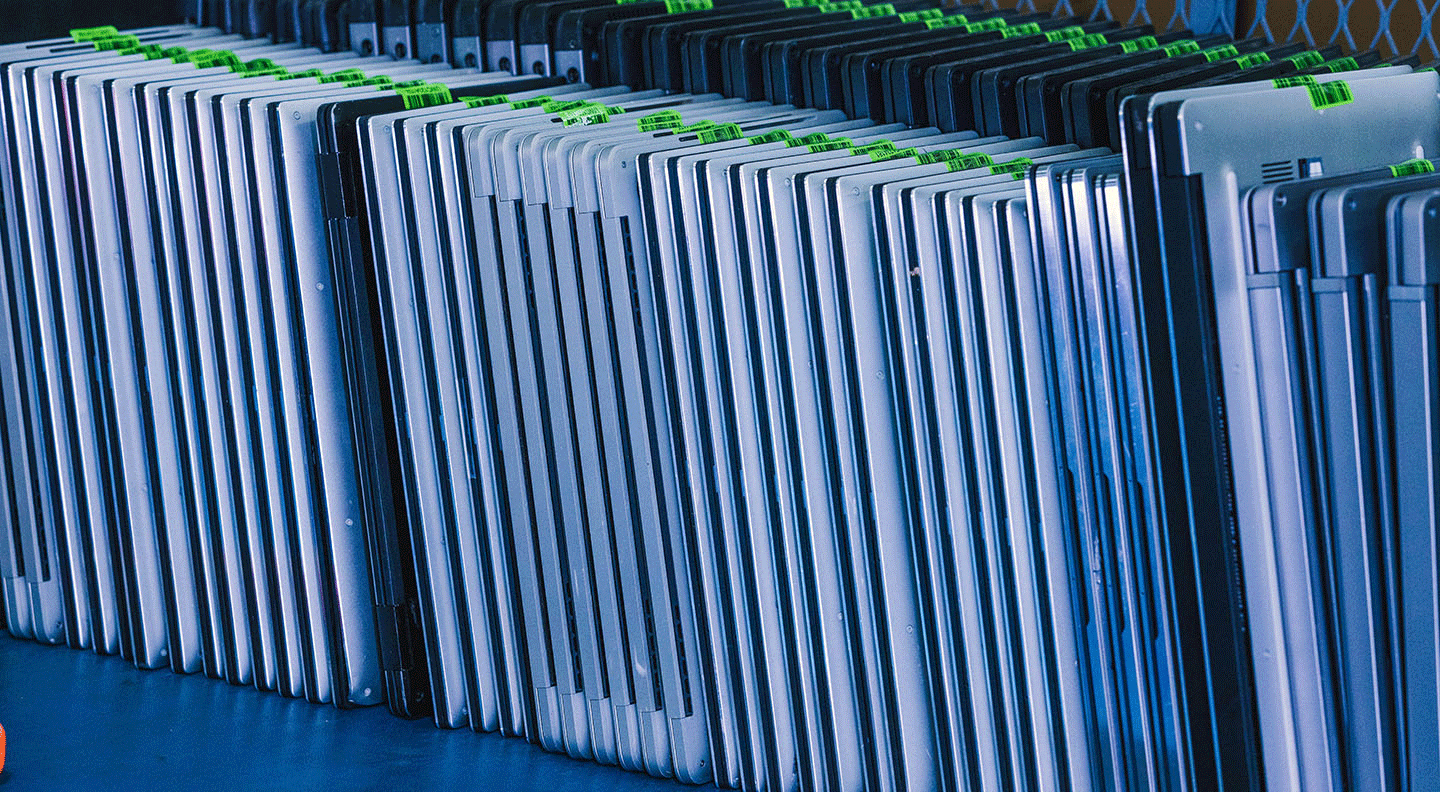 laptops stacked ready for refurbishment